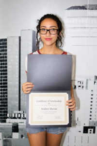 Jennifer Sacayon, Education is Forever scholarship recipient, proudly holds her Certificate of Scholarship, celebrating her academic achievement and commitment to pursuing higher education.